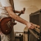 Musician setting guitar amp, studio recording session photo
